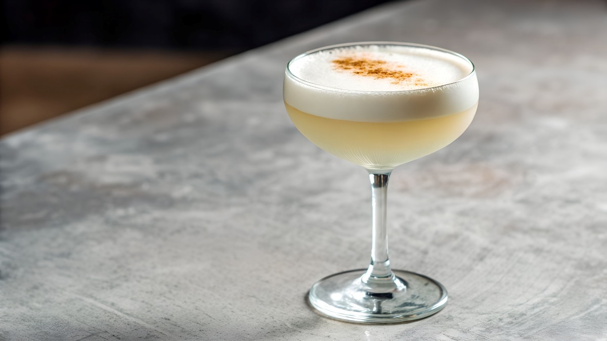 A Daiquiris Cocktail With Spices Garnishing The White Foam On A Concrete Bar